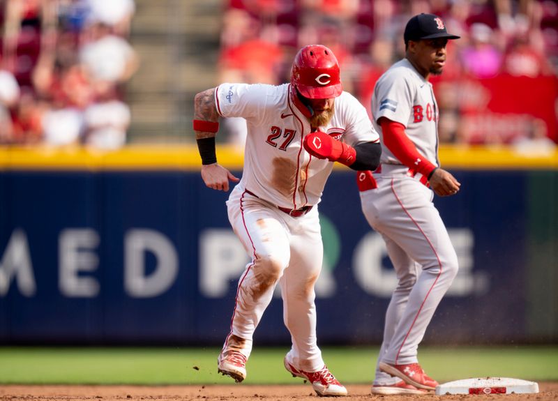 Jun 22, 2024; Cincinnati, Ohio, USA; Cincinnati Reds outfielder Jake Fraley (27) advances from first base to third base on a Cincinnati Reds second baseman Jonathan India (6) base hit in the sixth inning of the MLB baseball game between the Cincinnati Reds and the Boston Red Sox at Great American Ball Park in Cincinnati on Saturday, June 22, 2024. Mandatory Credit: Albert Cesare-The Cincinnati Enquirer-USA TODAY Sports