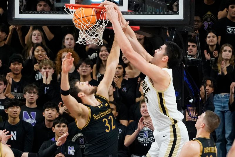 Dec 1, 2023; Evanston, Illinois, USA; Purdue Boilermakers center Zach Edey (15) dunks on Northwestern Wildcats forward Blake Preston (32) during the second half at Welsh-Ryan Arena. Mandatory Credit: David Banks-USA TODAY Sports