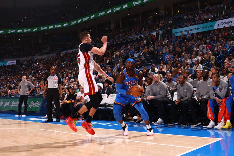 OKLAHOMA CITY, OK - MARCH 8:  Luguentz Dort #5 of the Oklahoma City Thunder handles the ball during the game against the Miami Heat on March 8, 2024 at Paycom Arena in Oklahoma City, Oklahoma. NOTE TO USER: User expressly acknowledges and agrees that, by downloading and or using this photograph, User is consenting to the terms and conditions of the Getty Images License Agreement. Mandatory Copyright Notice: Copyright 2024 NBAE (Photo by Zach Beeker/NBAE via Getty Images)