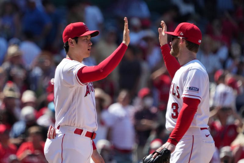 Jul 2, 2023; Anaheim, California, USA; Los Angeles Angels designated hitter Shohei Ohtani (17) and left fielder Taylor Ward (3) celebrate after the game against the Arizona Diamondbacks at Angel Stadium. Mandatory Credit: Kirby Lee-USA TODAY Sports