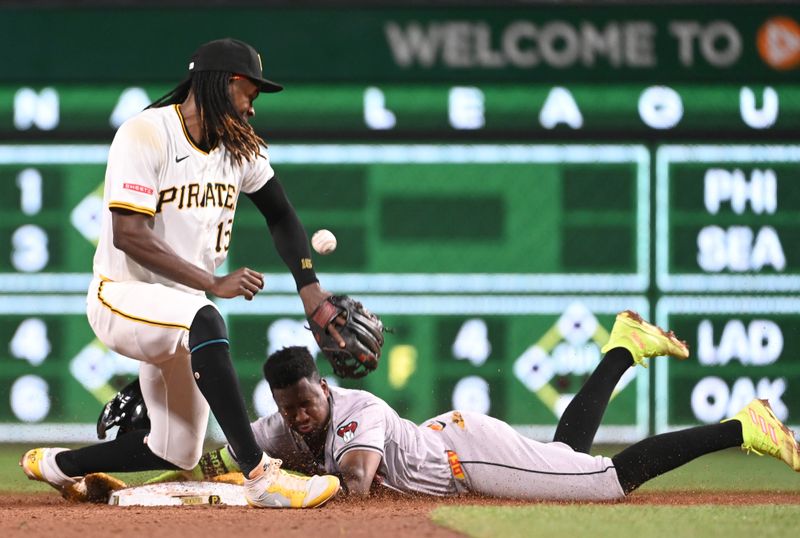 Aug 3, 2024; Pittsburgh, Pennsylvania, USA;  Arizona Diamondbacks base runner Geraldo Perdomo (2) makes it into second base for a double as Pittsburgh Pirates shortstop Oneil Cruz (15) handles the ball in the ninth inning at PNC Park. The Pirates won 4-2. Mandatory Credit: Philip G. Pavely-USA TODAY Sports