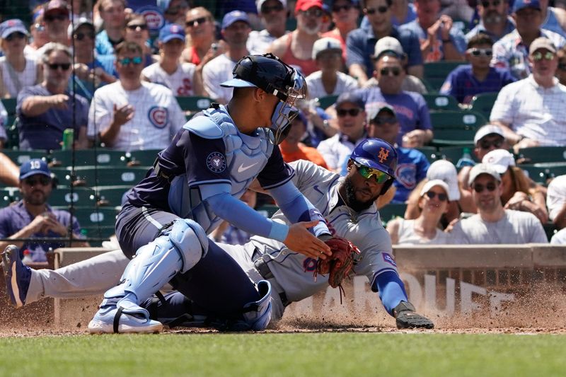 Jun 21, 2024; Chicago, Illinois, USA; New York Mets outfielder Starling Marte (6) is safe at home plate as Chicago Cubs catcher Miguel Amaya (9) makes a late tag during the fourth inning at Wrigley Field. Mandatory Credit: David Banks-USA TODAY Sports