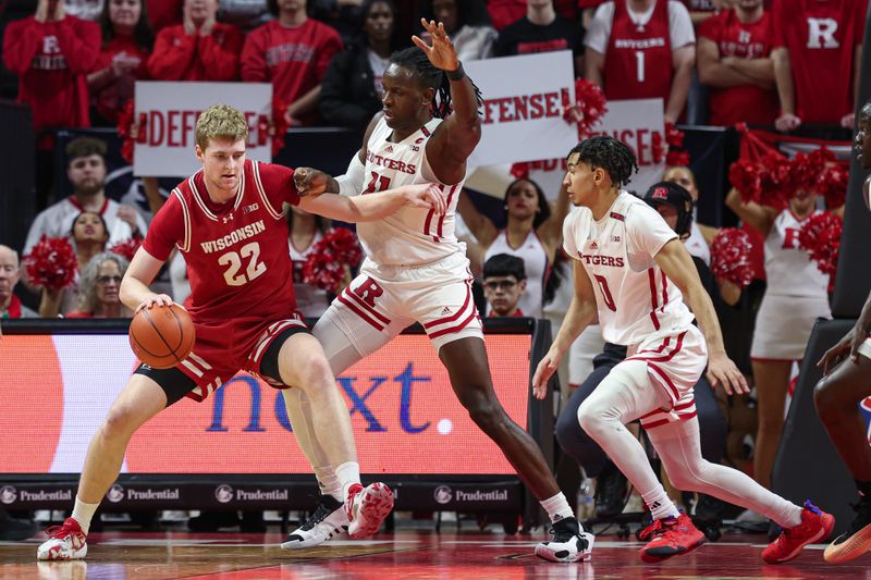 Feb 10, 2024; Piscataway, New Jersey, USA; Wisconsin Badgers forward Steven Crowl (22) dribbles the ball against Rutgers Scarlet Knights center Clifford Omoruyi (11) and guard Derek Simpson (0) during the second half at Jersey Mike's Arena. Mandatory Credit: Vincent Carchietta-USA TODAY Sports