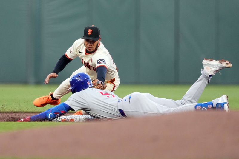 Jun 26, 2024; San Francisco, California, USA; Chicago Cubs third baseman Christopher Morel (front) is tagged out by San Francisco Giants second baseman Thairo Estrada (back) during the fourth inning at Oracle Park. The play was initially ruled safe until a video review overturned the call. Mandatory Credit: Darren Yamashita-USA TODAY Sports