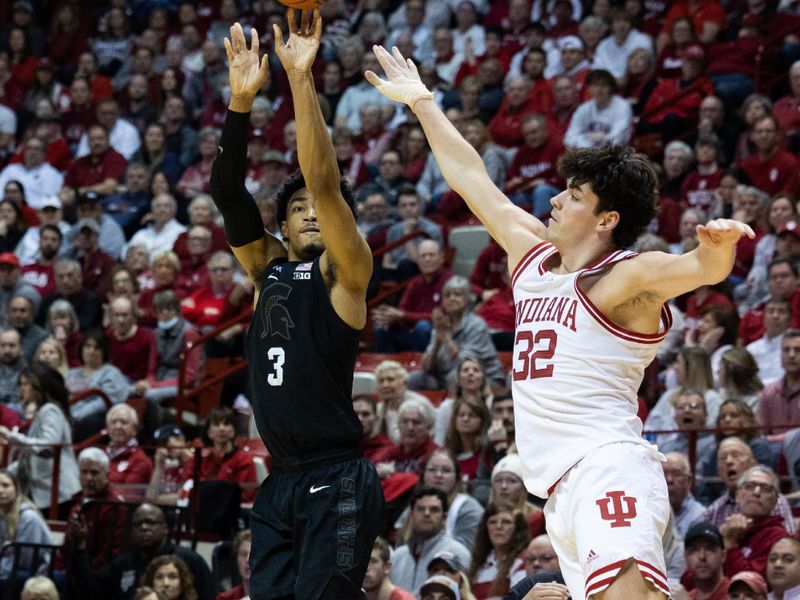 Jan 22, 2023; Bloomington, Indiana, USA; Michigan State Spartans guard Jaden Akins (3) shoots the ball while Indiana Hoosiers guard Trey Galloway (32) defends in the second half at Simon Skjodt Assembly Hall. Mandatory Credit: Trevor Ruszkowski-USA TODAY Sports