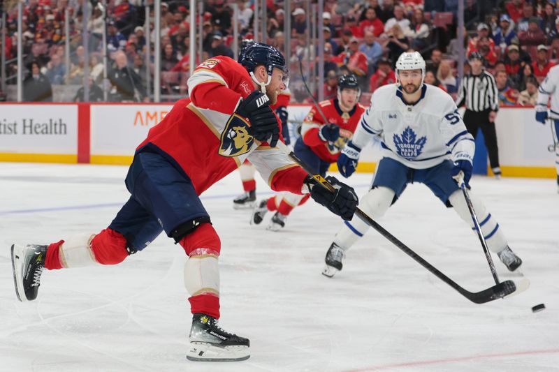 Dec 2, 2025; Sunrise, Florida, USA; Florida Panthers center Sam Bennett (9) shoots the puck against the Toronto Maple Leafs during the third period at Amerant Bank Arena. Mandatory Credit: Sam Navarro-Imagn Images