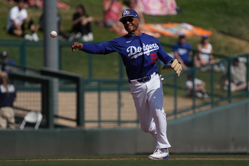 Mar 16, 2026; Phoenix, Arizona, USA; Los Angeles Dodgers shortstop Mookie Betts (50) fields the ball against the Milwaukee Brewers in the third inning at Camelback Ranch-Glendale. Mandatory Credit: Rick Scuteri-Imagn Images