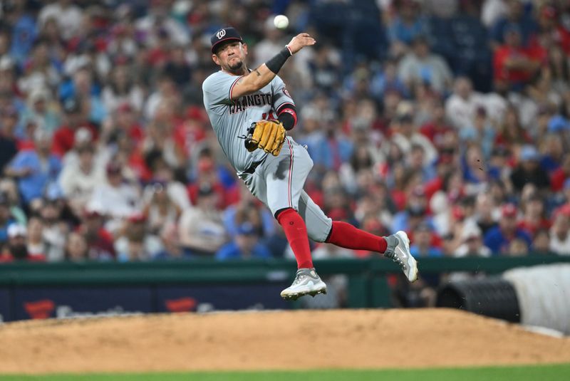 Aug 17, 2024; Philadelphia, Pennsylvania, USA; Washington Nationals infielder Ildemaro Vargas (14) throws to first against the Philadelphia Phillies in the eighth inning at Citizens Bank Park. Mandatory Credit: Kyle Ross-USA TODAY Sports