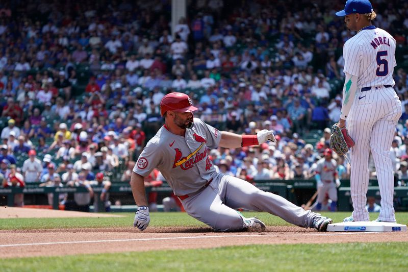 Jun 16, 2024; Chicago, Illinois, USA; St. Louis Cardinals first baseman Paul Goldschmidt (46) slides safely into third base as Chicago Cubs third baseman Christopher Morel (5) stands nearby during the first inning at Wrigley Field. Mandatory Credit: David Banks-USA TODAY Sports