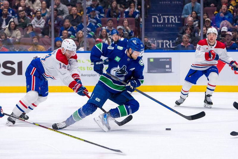 Mar 21, 2024; Vancouver, British Columbia, CAN; Montreal Canadiens forward Nick Suzuki (14) trips up Vancouver Canucks forward Elias Pettersson (40) in the first period at Rogers Arena. Mandatory Credit: Bob Frid-USA TODAY Sports