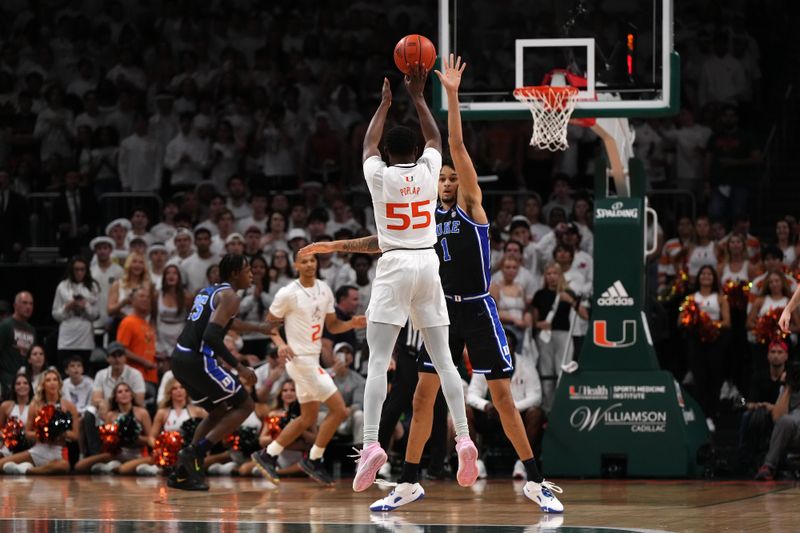 Feb 6, 2023; Coral Gables, Florida, USA; Miami Hurricanes guard Wooga Poplar (55) attempts a three point shot against the Duke Blue Devils during the first half at Watsco Center. Mandatory Credit: Jasen Vinlove-USA TODAY Sports