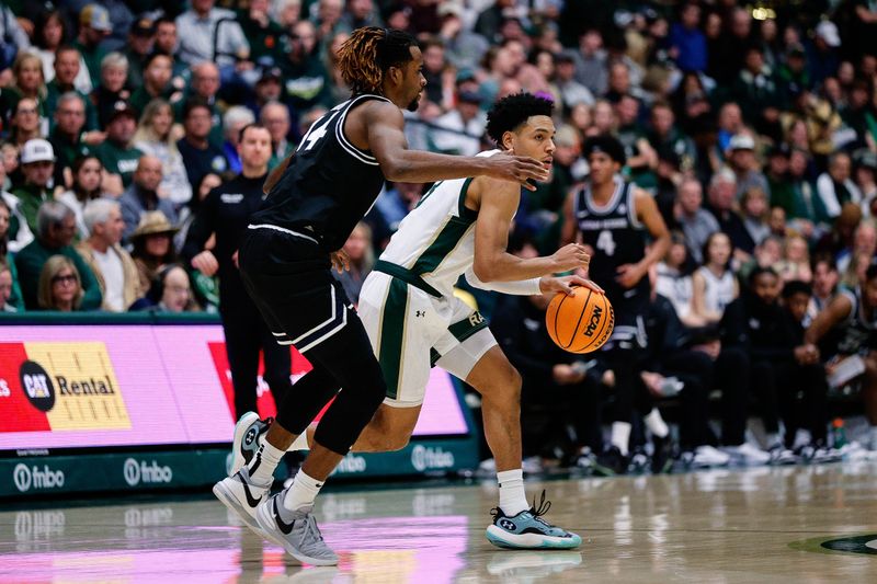 Feb 17, 2024; Fort Collins, Colorado, USA; Colorado State Rams guard Josiah Strong (3) controls the ball as Utah State Aggies guard Josh Uduje (14) guards in the second half at Moby Arena. Mandatory Credit: Isaiah J. Downing-USA TODAY Sports