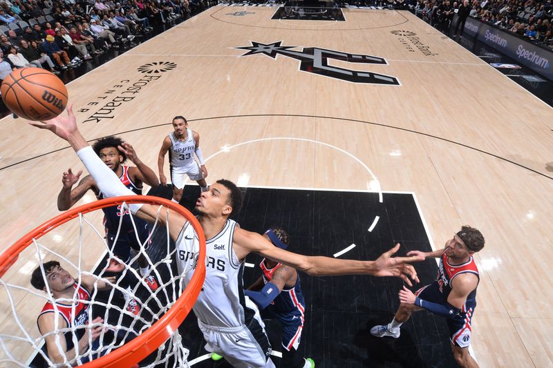 SAN ANTONIO, TX - JANUARY 29:  Victor Wembanyama #1 of the San Antonio Spurs rebounds the ball during the game  against the Washington Wizards on January 29, 2024 at the Frost Bank Center in San Antonio, Texas. NOTE TO USER: User expressly acknowledges and agrees that, by downloading and or using this photograph, user is consenting to the terms and conditions of the Getty Images License Agreement. Mandatory Copyright Notice: Copyright 2024 NBAE (Photos by Michael Gonzales/NBAE via Getty Images)