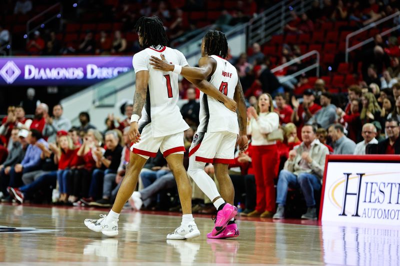 Jan 30, 2024; Raleigh, North Carolina, USA; North Carolina State Wolfpack guard Jayden Taylor (1) and guard DJ Horne (0) hug during the second half against Miami (Fl) Hurricanes at PNC Arena. Mandatory Credit: Jaylynn Nash-USA TODAY Sports