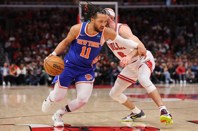 CHICAGO, ILLINOIS - APRIL 09: Jalen Brunson #11 of the New York Knicks drives to the basket against Alex Caruso #6 of the Chicago Bulls during the first half at the United Center on April 09, 2024 in Chicago, Illinois. NOTE TO USER: User expressly acknowledges and agrees that, by downloading and or using this photograph, User is consenting to the terms and conditions of the Getty Images License Agreement.  (Photo by Michael Reaves/Getty Images)