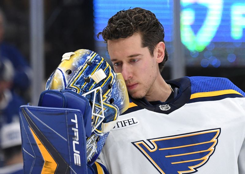 Jan 3, 2023; Toronto, Ontario, CAN; St. Louis Blues goalie Jordan Binnington (50) looks into his mask before play begins in the first period against the Toronto Maple Leafs at Scotiabank Arena. Mandatory Credit: Dan Hamilton-USA TODAY Sports