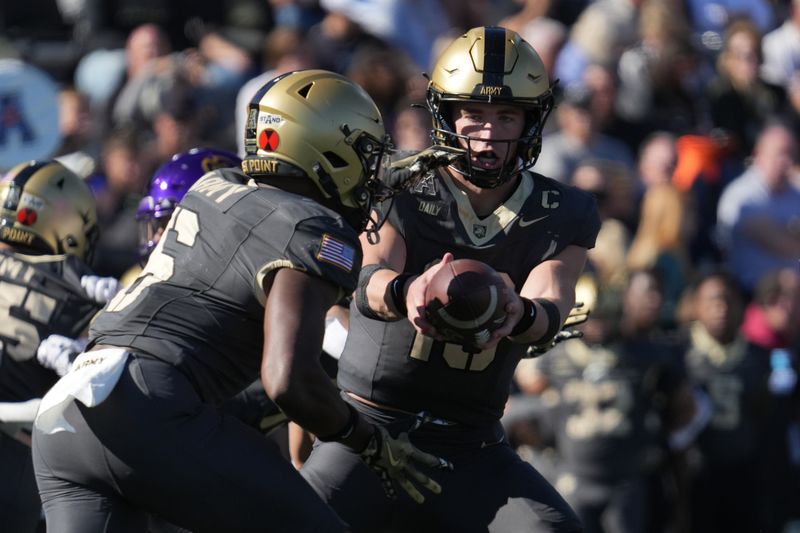 Oct 19, 2024; West Point, New York, USA; Army Black Knights quarterback Bryson Daily (13) hands a ball to Army Black Knights running back Kanye Udoh (6) during the second half against the East Carolina Pirates at Michie Stadium. Mandatory Credit: Lucas Boland-Imagn Images
