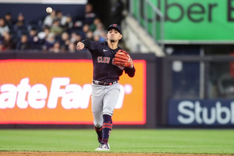 May 1, 2023; Bronx, New York, USA;  Cleveland Guardians second baseman Andres Gimenez (0) throws a runner out at first base in the sixth inning against the New York Yankees at Yankee Stadium. Mandatory Credit: Wendell Cruz-USA TODAY Sports