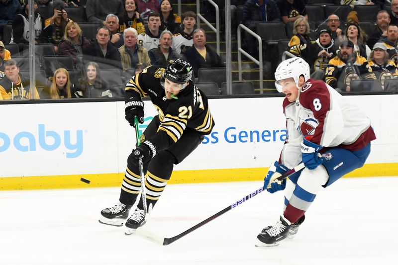 Jan 18, 2024; Boston, Massachusetts, USA; Boston Bruins left wing James van Riemsdyk (21) shoots the puck while Colorado Avalanche defenseman Cale Makar (8) defends during the first period at TD Garden. Mandatory Credit: Bob DeChiara-USA TODAY Sports