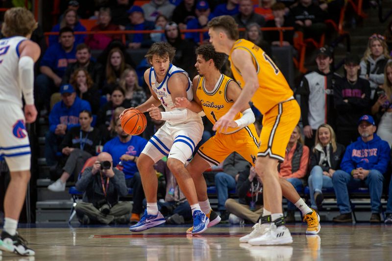 Feb 11, 2023; Boise, Idaho, USA; Boise State Broncos forward Tyson Degenhart (2) dribbles against Wyoming Cowboys guard Brendan Wenzel (1) during the first half s at ExtraMile Arena. Mandatory Credit: Brian Losness-USA TODAY Sports

