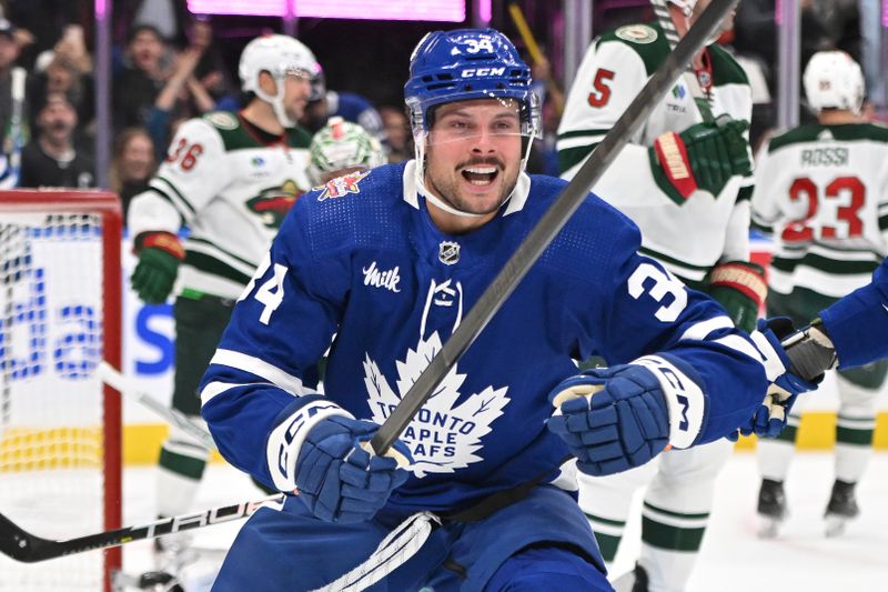 Oct 14, 2023; Toronto, Ontario, CAN;  Toronto Maple Leafs forward Auston Matthews (34) celebrates after scoring his third goal of the game against the Minnesota Wild in the third period at Scotiabank Arena. Mandatory Credit: Dan Hamilton-USA TODAY Sports