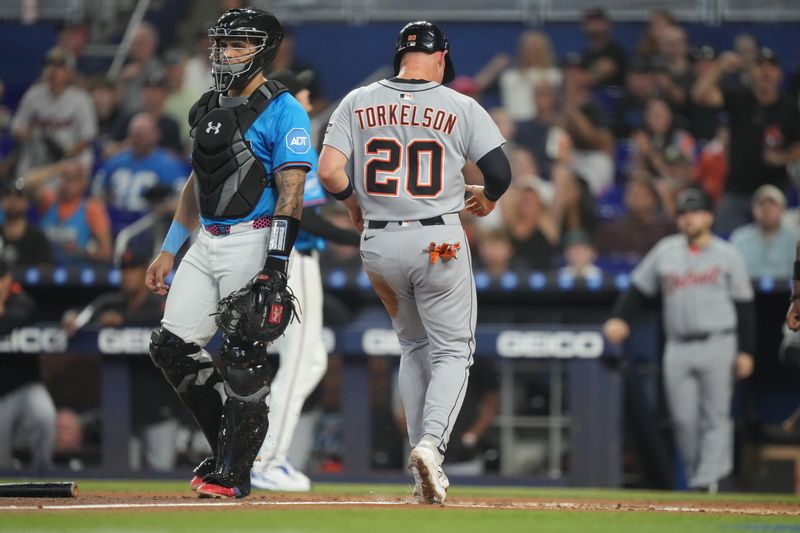 Sep 14, 2025; Miami, Florida, USA;  Detroit Tigers first baseman Spencer Torkelson (20) scores a run in the second inning as Miami Marlins catcher Agustin Ramirez (50) looks on in the second inning at loanDepot Park. Mandatory Credit: Jim Rassol-Imagn Images
