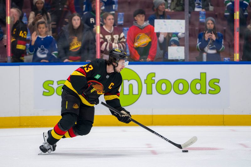 Nov 9, 2024; Vancouver, British Columbia, CAN; Vancouver Canucks defenseman Quinn Hughes (43) handles the puck during warm up prior to a game against the Edmonton Oilers at Rogers Arena. Mandatory Credit: Bob Frid-Imagn Images