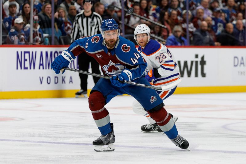 Jan 16, 2025; Denver, Colorado, USA; Colorado Avalanche defenseman Calvin de Haan (44) watches a loose puck ahead of Edmonton Oilers right wing Connor Brown (28) in the first period at Ball Arena. Mandatory Credit: Isaiah J. Downing-Imagn Images