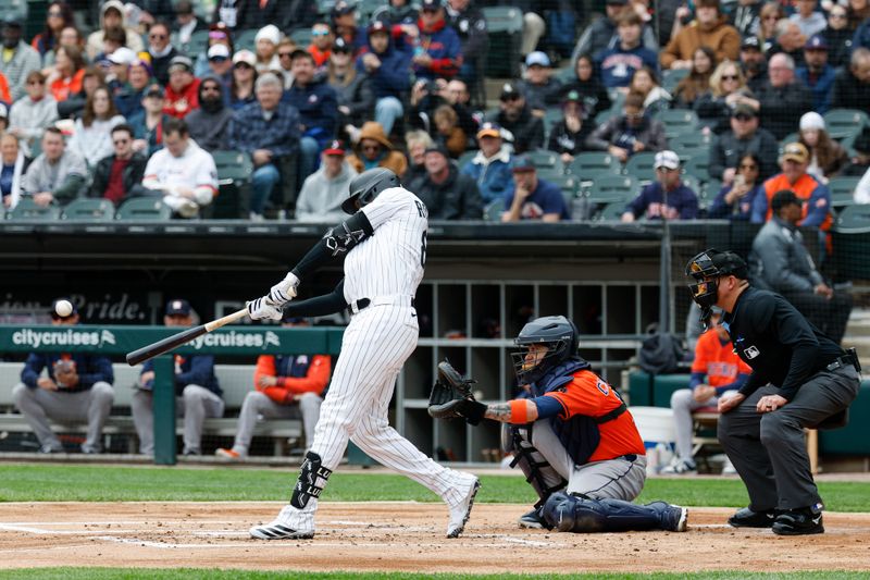 May 4, 2025; Chicago, Illinois, USA; Chicago White Sox center fielder Luis Robert Jr. (88) singles against the Houston Astros during the first inning at Rate Field. Mandatory Credit: Kamil Krzaczynski-Imagn Images