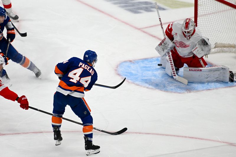 Nov 25, 2024; Elmont, New York, USA;  Detroit Red Wings goaltender Alex Lyon (34) makes a save on New York Islanders center Jean-Gabriel Pageau (44) during the first period at UBS Arena. Mandatory Credit: Dennis Schneidler-Imagn Images