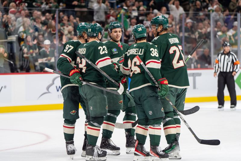 Oct 1, 2024; Saint Paul, Minnesota, USA; Minnesota Wild center Marco Rossi (23) scores and teammates congratulate him against the Chicago Blackhawks in the second period at Xcel Energy Center. Mandatory Credit: Matt Blewett-Imagn Images