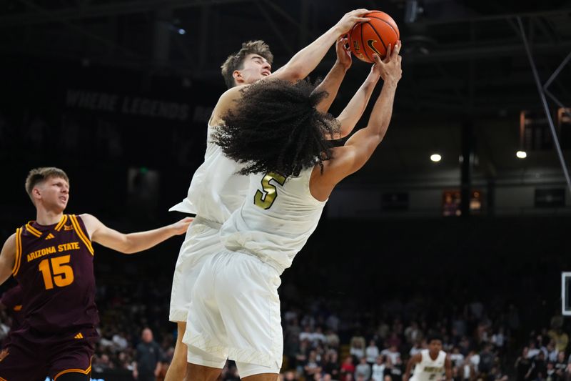 Feb 7, 2026; Boulder, Colorado, USA; Colorado Buffaloes forward Sebastian Rancik (7) and guard Josiah Sanders (5) reach for the ball in the second half against the Arizona State Sun Devils at the CU Events Center. Mandatory Credit: Ron Chenoy-Imagn Images