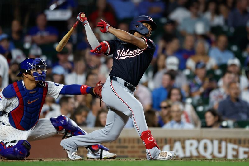 Sep 19, 2024; Chicago, Illinois, USA; Washington Nationals third baseman Jose Tena (8) hits an RBI single against the Chicago Cubs during the third inning at Wrigley Field. Mandatory Credit: Kamil Krzaczynski-Imagn Images