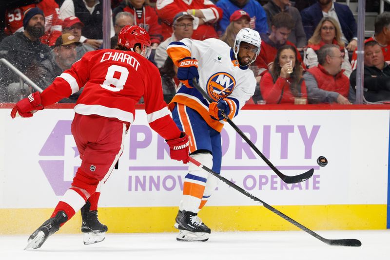 Nov 20, 2025; Detroit, Michigan, USA;  New York Islanders left wing Anthony Duclair (11) passes defended by Detroit Red Wings defenseman Ben Chiarot (8) in the first period at Little Caesars Arena. Mandatory Credit: Rick Osentoski-Imagn Images