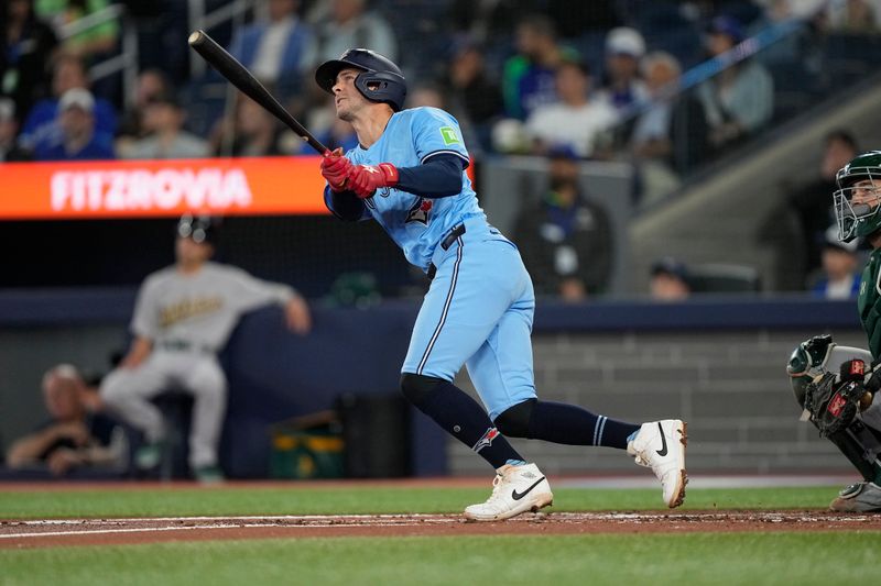 May 29, 2025; Toronto, Ontario, CAN; Toronto Blue Jays third baseman Ernie Clement (22) hits a three run home run against the Athletics during the second inning at Rogers Centre. Mandatory Credit: John E. Sokolowski-Imagn Images