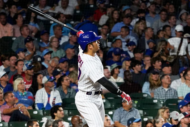 Jul 18, 2023; Chicago, Illinois, USA; Chicago Cubs right fielder Seiya Suzuki (27) hits a home run against the Washington Nationals during the sixth inning at Wrigley Field. Mandatory Credit: David Banks-USA TODAY Sports