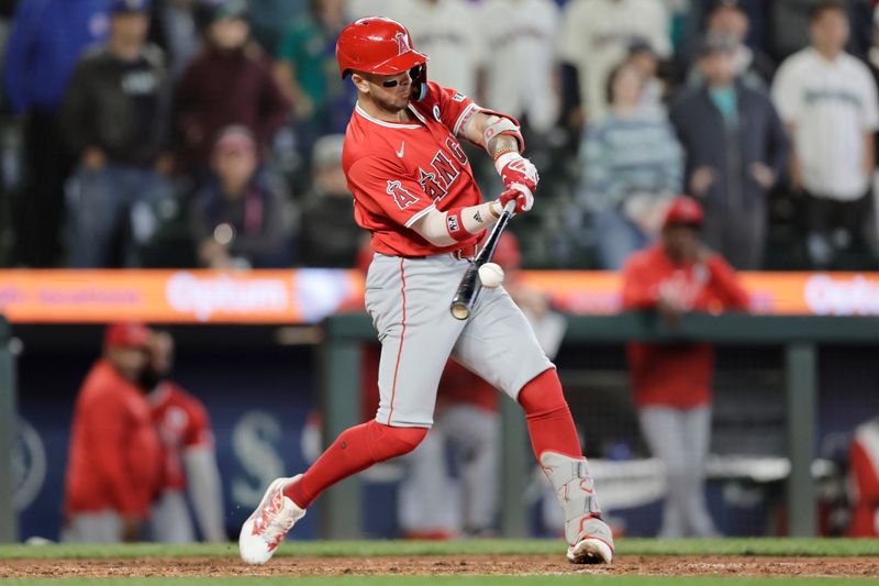 Jun 2, 2024; Seattle, Washington, USA; Los Angeles Angels short stop Zach Neto (9) hits an RBI single against the Seattle Mariners during the ninth inning at T-Mobile Park. Mandatory Credit: John Froschauer-USA TODAY Sports