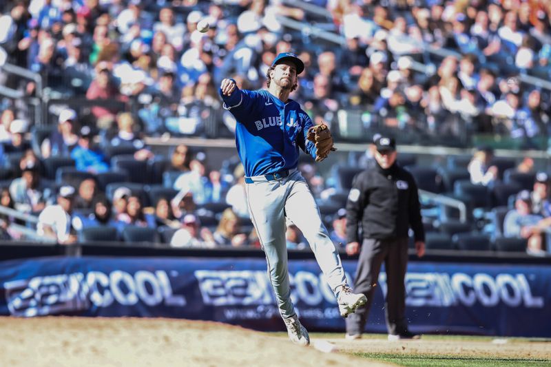 Apr 7, 2024; Bronx, New York, USA;  Toronto Blue Jays third baseman Ernie Clement (28) makes an off balanced throw to first base in the sixth inning against the New York Yankees at Yankee Stadium. Mandatory Credit: Wendell Cruz-USA TODAY Sports