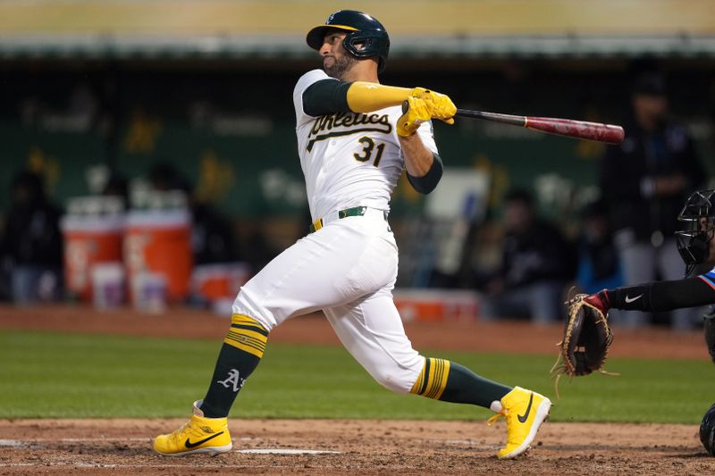 May 3, 2024; Oakland, California, USA; Oakland Athletics second baseman Abraham Toro (31) hits a double against the Miami Marlins during the sixth inning at Oakland-Alameda County Coliseum. Mandatory Credit: Darren Yamashita-USA TODAY Sports