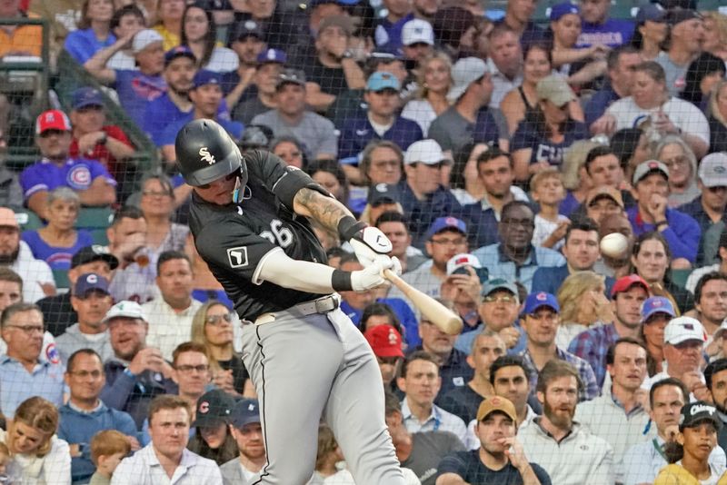 Jun 4, 2024; Chicago, Illinois, USA; Chicago White Sox catcher Korey Lee (26) hits a two-run double against the Chicago Cubs during the fourth inning at Wrigley Field. Mandatory Credit: David Banks-USA TODAY Sports