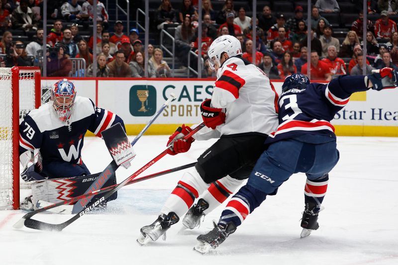 Feb 20, 2024; Washington, District of Columbia, USA; Washington Capitals goaltender Charlie Lindgren (79) makes a save on New Jersey Devils right wing Nathan Bastian (14) as Capitals defenseman Nick Jensen (3) defends in the first period at Capital One Arena. Mandatory Credit: Geoff Burke-USA TODAY Sports