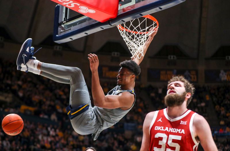 Feb 4, 2023; Morgantown, West Virginia, USA; West Virginia Mountaineers forward Mohamed Wague (11) dunks the ball during the second half against the Oklahoma Sooners at WVU Coliseum. Mandatory Credit: Ben Queen-USA TODAY Sports