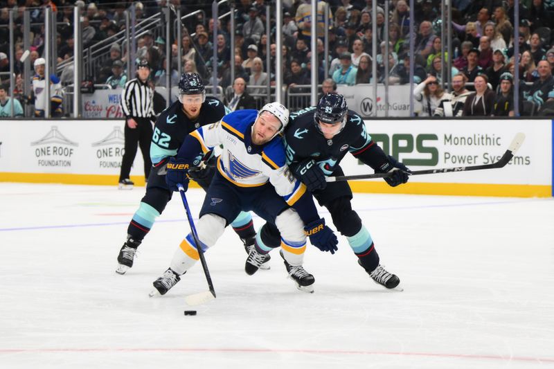 Apr 12, 2025; Seattle, Washington, USA; Seattle Kraken center Ryan Winterton (26) plays the puck while defended by Seattle Kraken left wing Andre Burakovsky (95) during the first period at Climate Pledge Arena. Mandatory Credit: Steven Bisig-Imagn Images