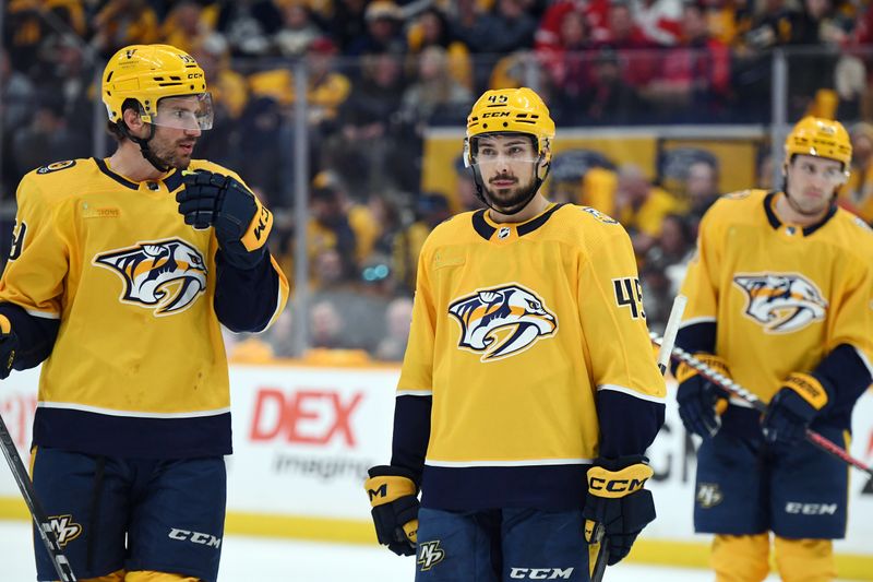 Mar 23, 2024; Nashville, Tennessee, USA; Nashville Predators defenseman Roman Josi (59) talks with defenseman Alexandre Carrier (45) before a face off during the third period against the Detroit Red Wings at Bridgestone Arena. Mandatory Credit: Christopher Hanewinckel-USA TODAY Sports