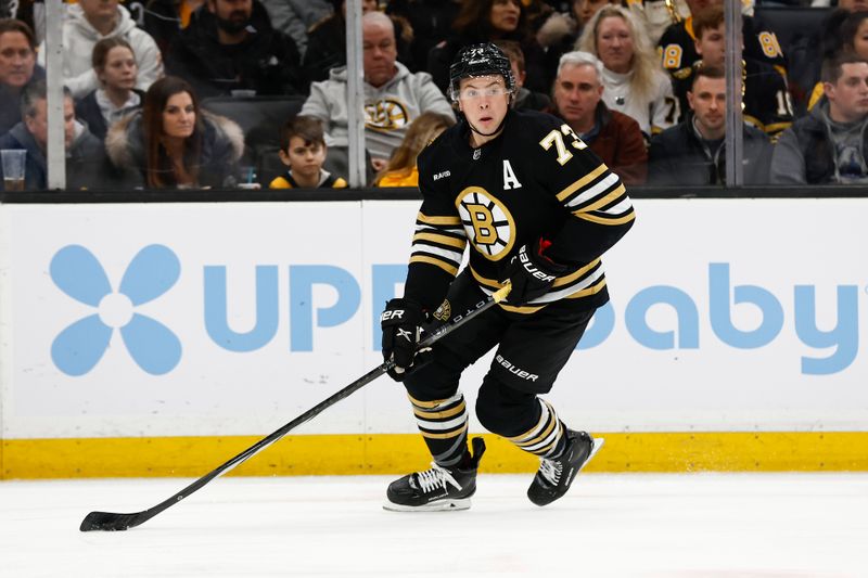 Jan 22, 2024; Boston, Massachusetts, USA; Boston Bruins defenseman Charlie McAvoy (73) carries the puck against the Winnipeg Jets during the first period at TD Garden. Mandatory Credit: Winslow Townson-USA TODAY Sports