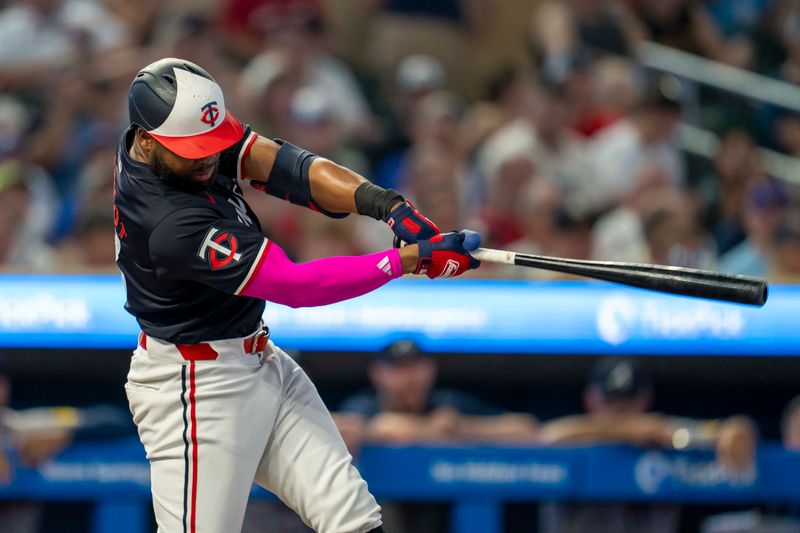 Aug 26, 2024; Minneapolis, Minnesota, USA; Minnesota Twins left fielder Manuel Margot (13) hits a double against the Atlanta Braves in the first inning at Target Field. Mandatory Credit: Jesse Johnson-USA TODAY Sports