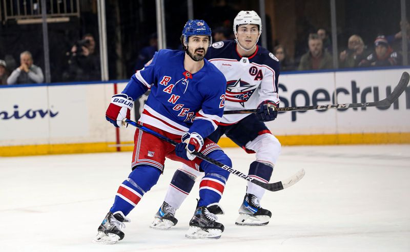 Jan 18, 2025; New York, New York, USA; New York Rangers left wing Chris Kreider (20) is defended by Columbus Blue Jackets defenseman Zach Werenski (8)  during the first period at Madison Square Garden. Mandatory Credit: Danny Wild-Imagn Images