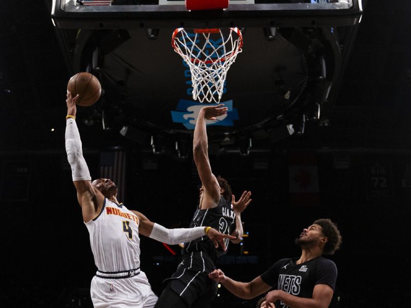 NEW YORK, NEW YORK - OCTOBER 29: Russell Westbrook #4 of the Denver Nuggets goes to the basket Nic Claxton #33 of the Brooklyn Nets during the second half at Barclays Center on October 29, 2024 in New York City.<p><br/></p>NOTE TO USER: User expressly acknowledges and agrees that, by downloading and or using this Photograph, user is consenting to the terms and conditions of the Getty Images License Agreement. (Photo by Michelle Farsi/Getty Images)