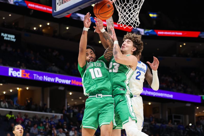 North Texas Mean Green guard Cole Franklin (10) and forward Buddy Hammer Jr. (23) jump for a rebound during the first half against the Memphis Tigers Dec 31, 2025; Memphis, Tennessee, USA; at FedExForum. Mandatory Credit: Wesley Hale-Imagn Images