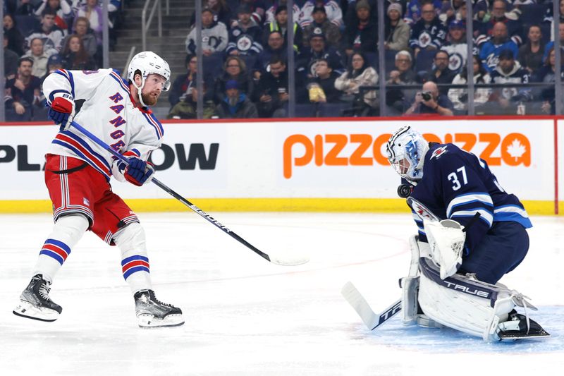 Oct 30, 2023; Winnipeg, Manitoba, CAN; Winnipeg Jets goaltender Connor Hellebuyck (37) makes a save on New York Rangers left wing Alexis Lafreniere (13) in the first period at Canada Life Centre. Mandatory Credit: James Carey Lauder-USA TODAY Sports